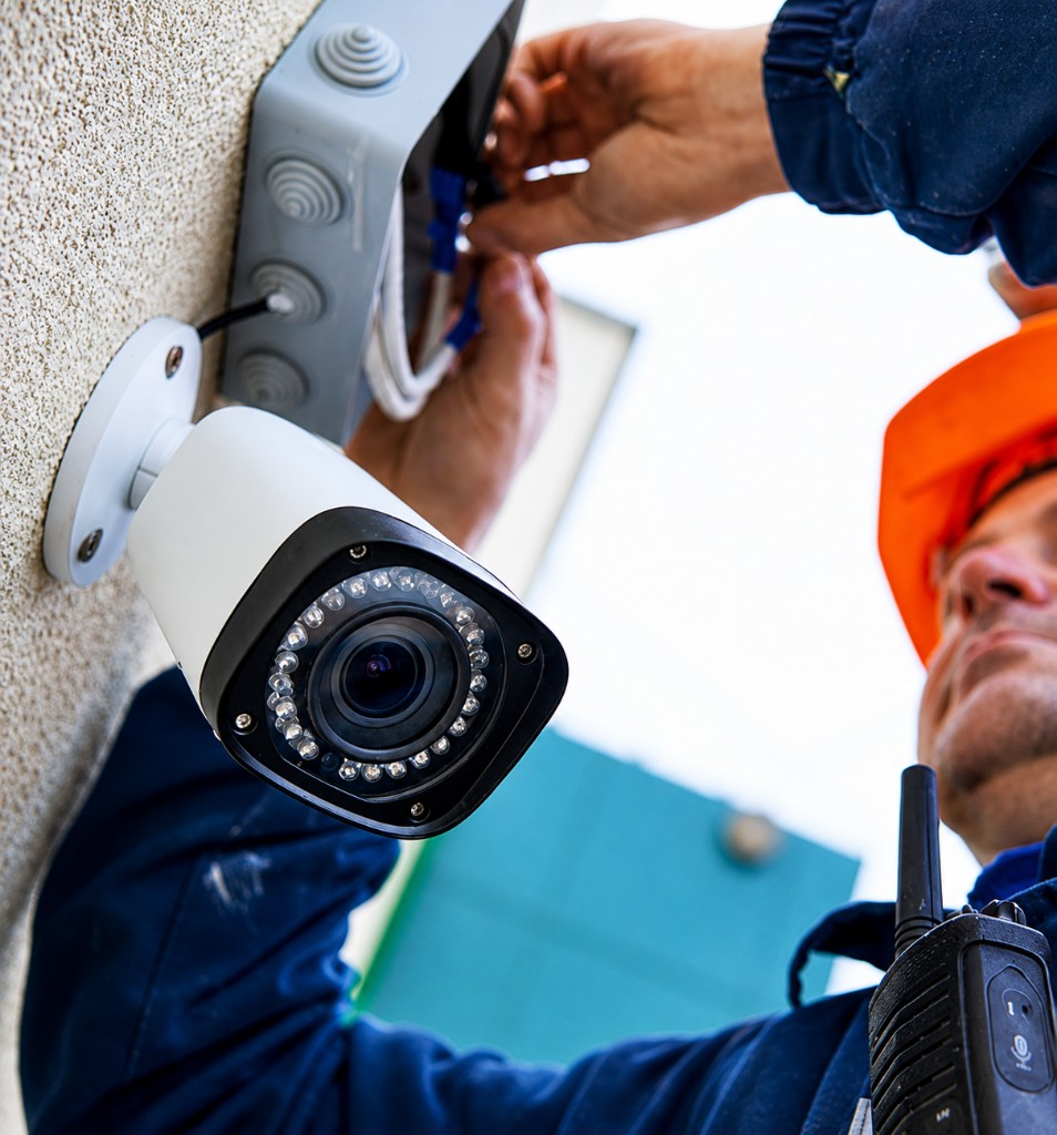 Technical service technician installing a security camera during a field service visit